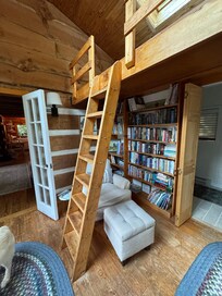 Cozy reading nook with a loft and greenhouse window.