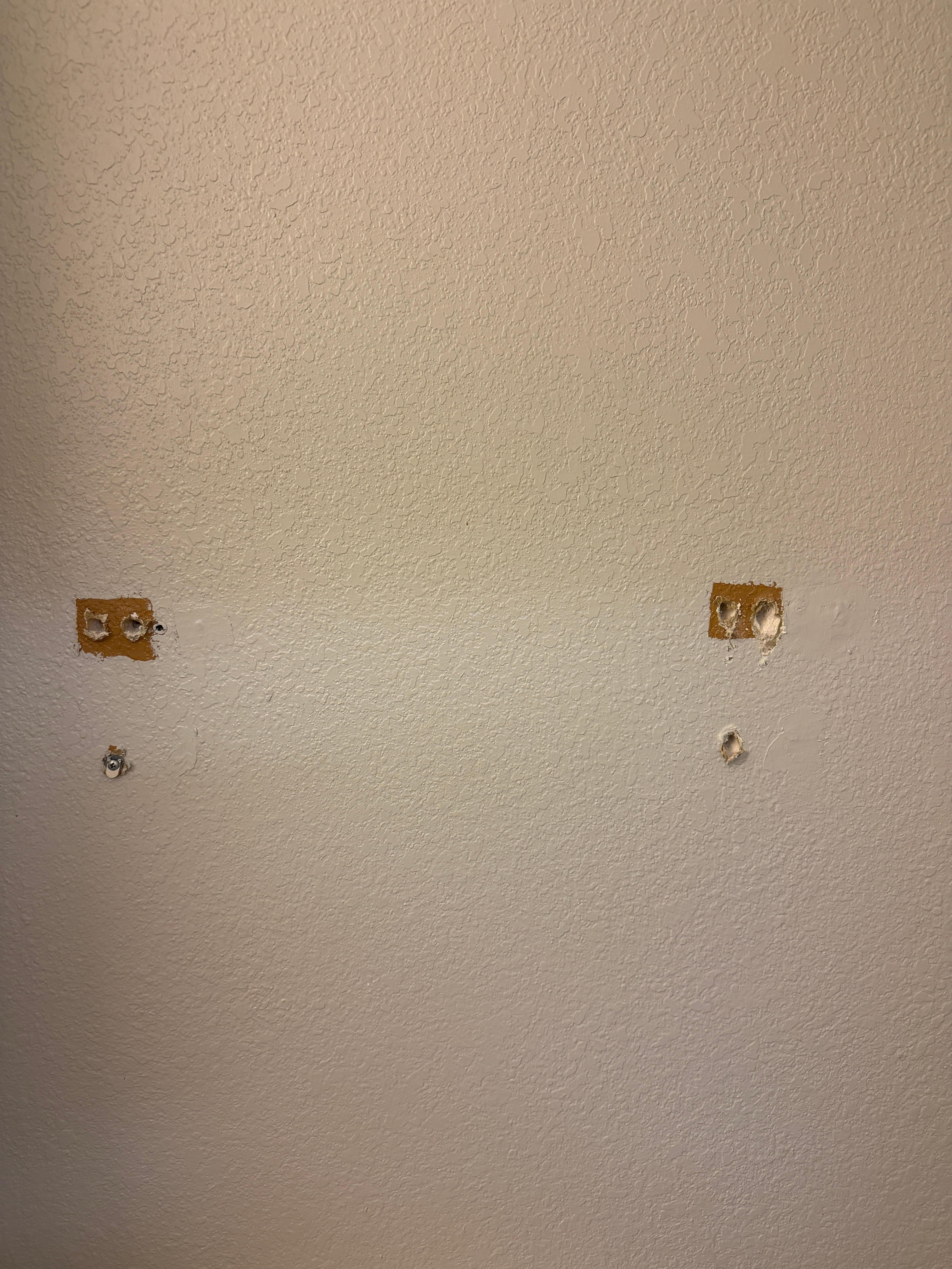 Holes in the bathroom wall. 