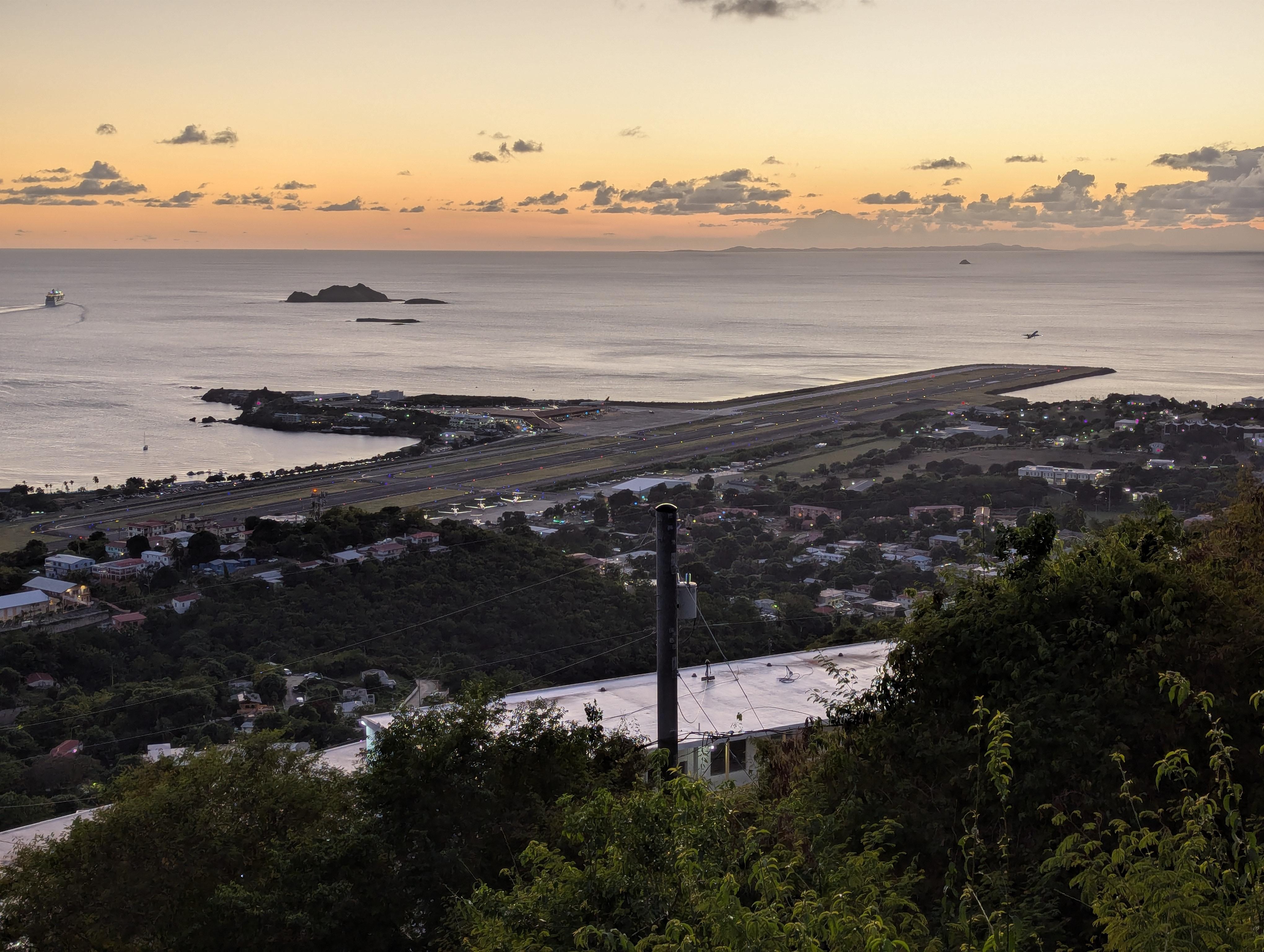 Delta 757 aircraft taking off from Cyril E. King Airport at Dusk
