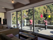 Staff waving to people on the Kurobe railway