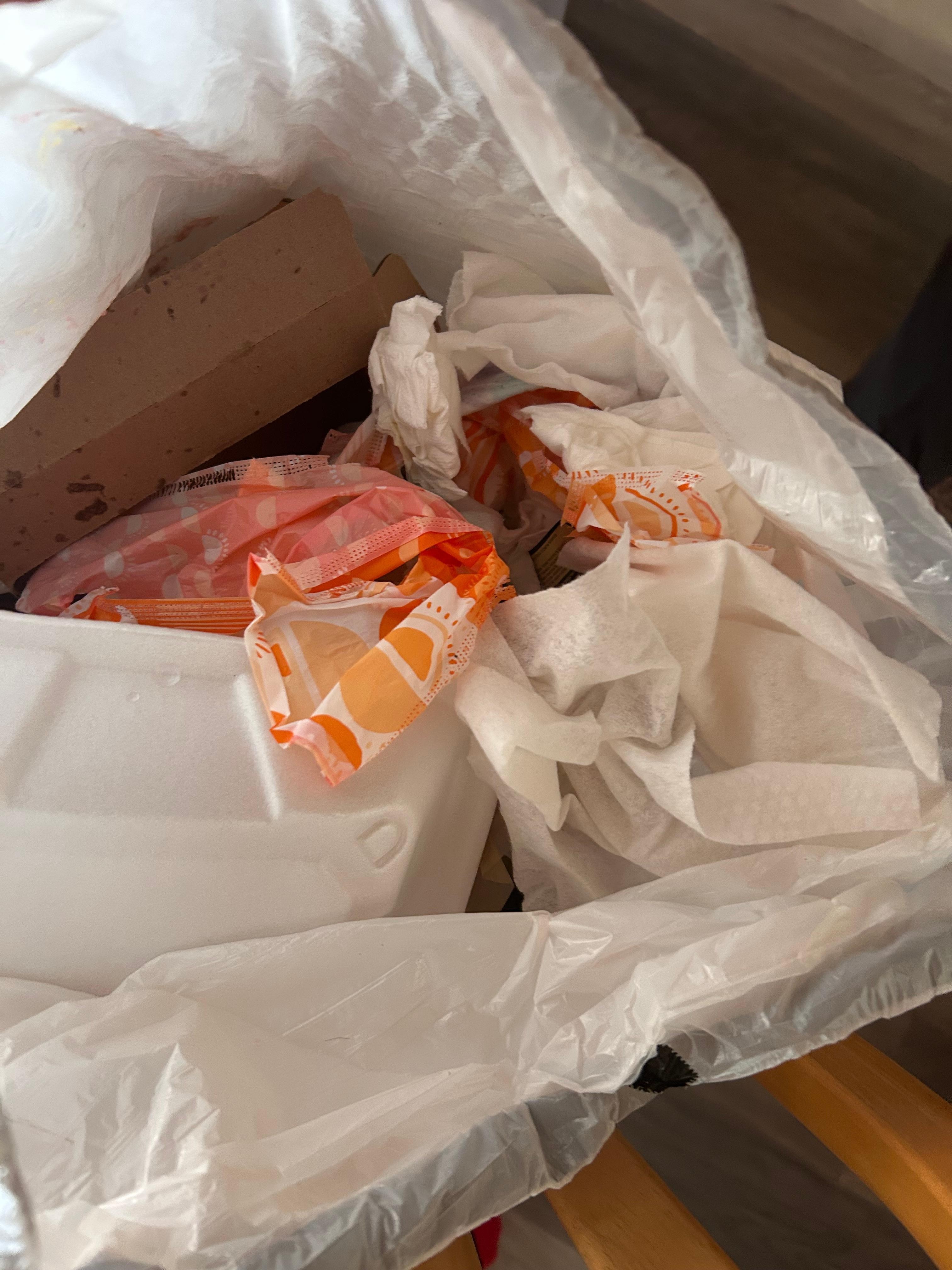 Trash left behind from others before us; soiled feminine products 