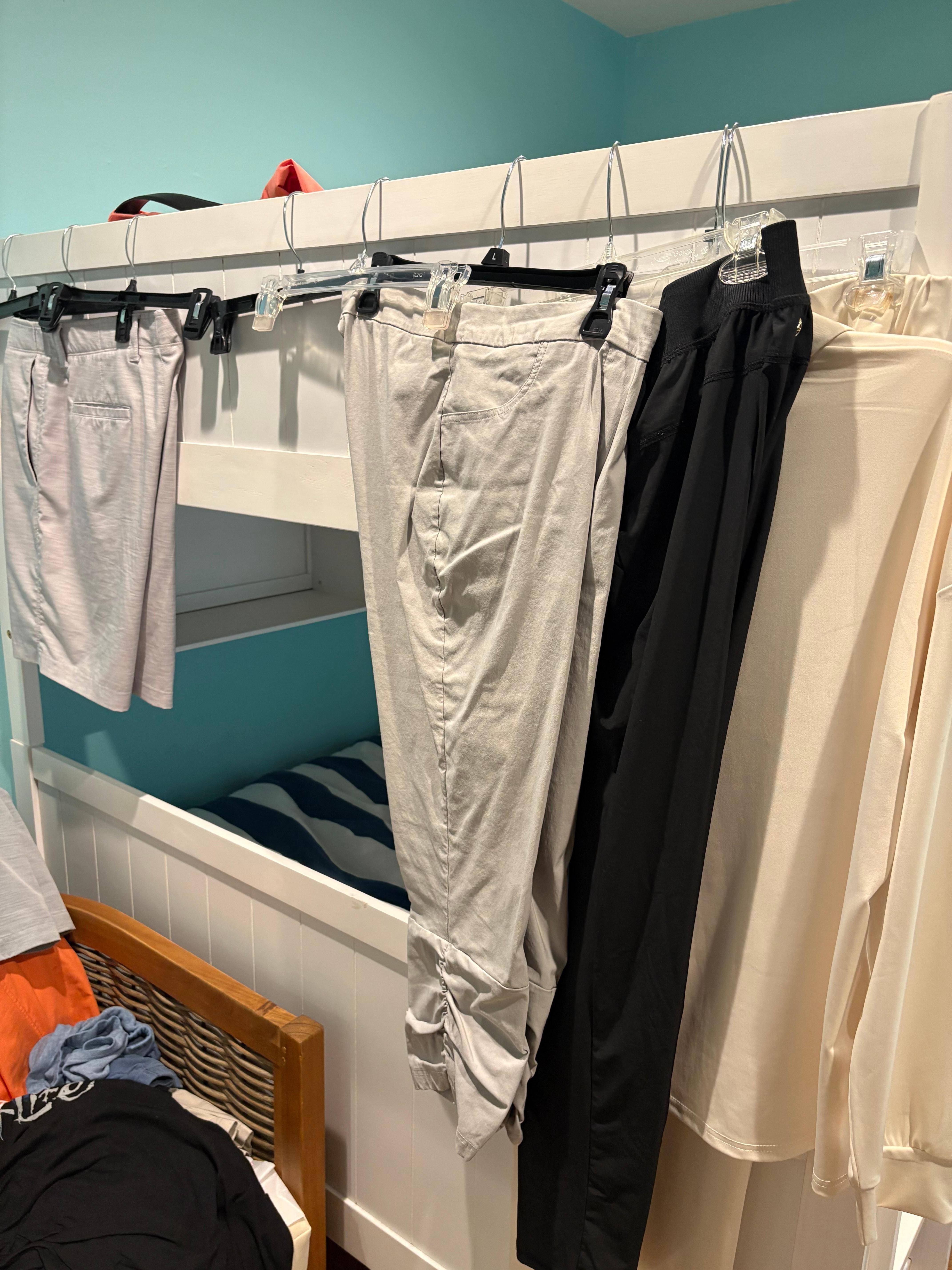 clothes hanging on bunk bed