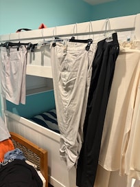 clothes hanging on bunk bed