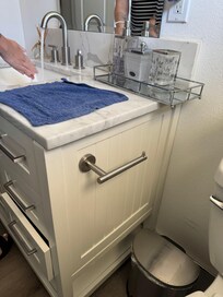 Wet towel on counter in bathroom with broken drawer in view. Timestamp is Friday at 5:14 pm.