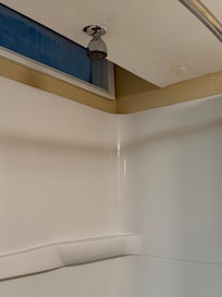 Shower head culked on the ceiling, very low pressure and the water wasn’t even hot