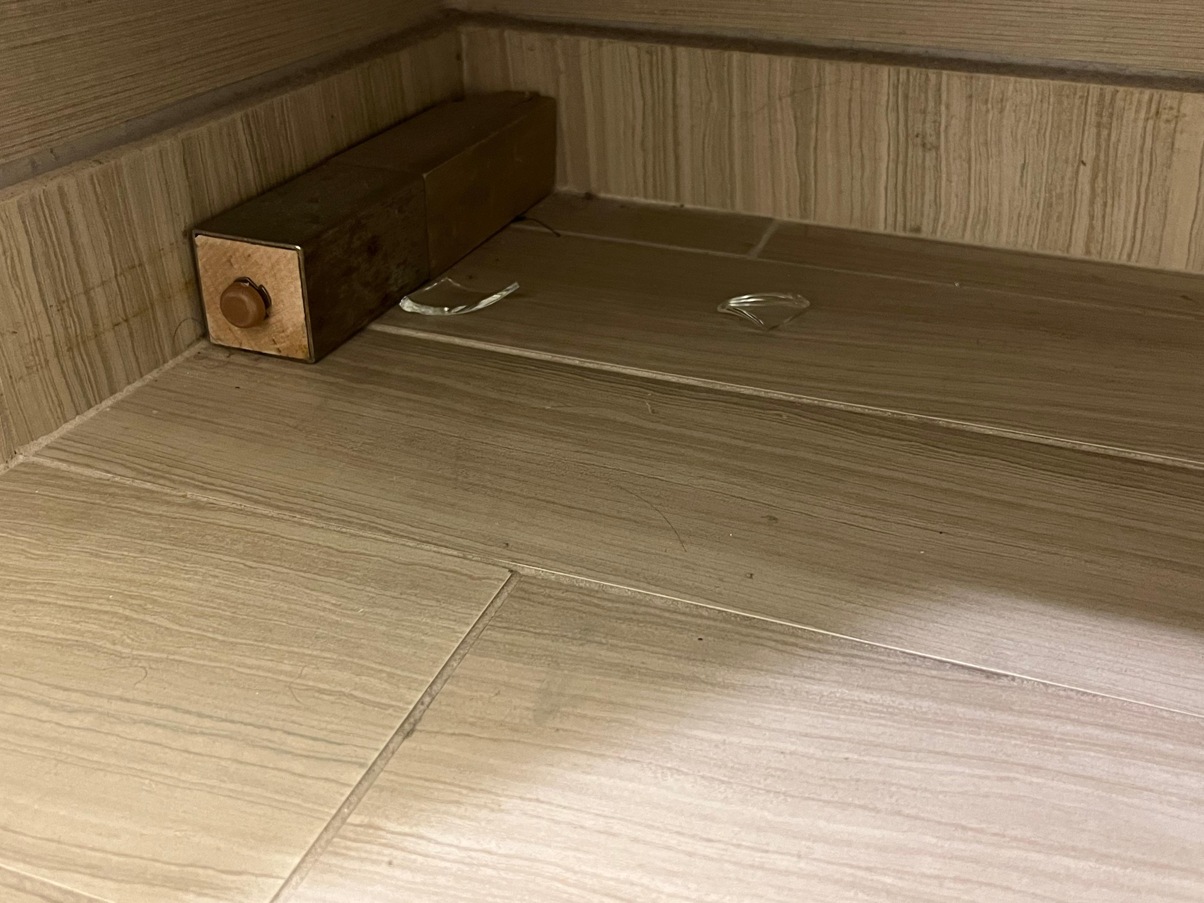 Glass shards on the bathroom floor