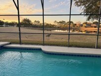 View of the green space behind the home- and our sandhill crane friends