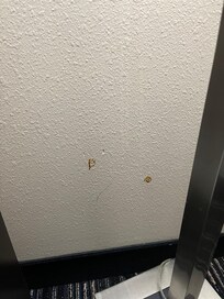 Wall by the TV in room 202, I hope pizza sauce and not blood