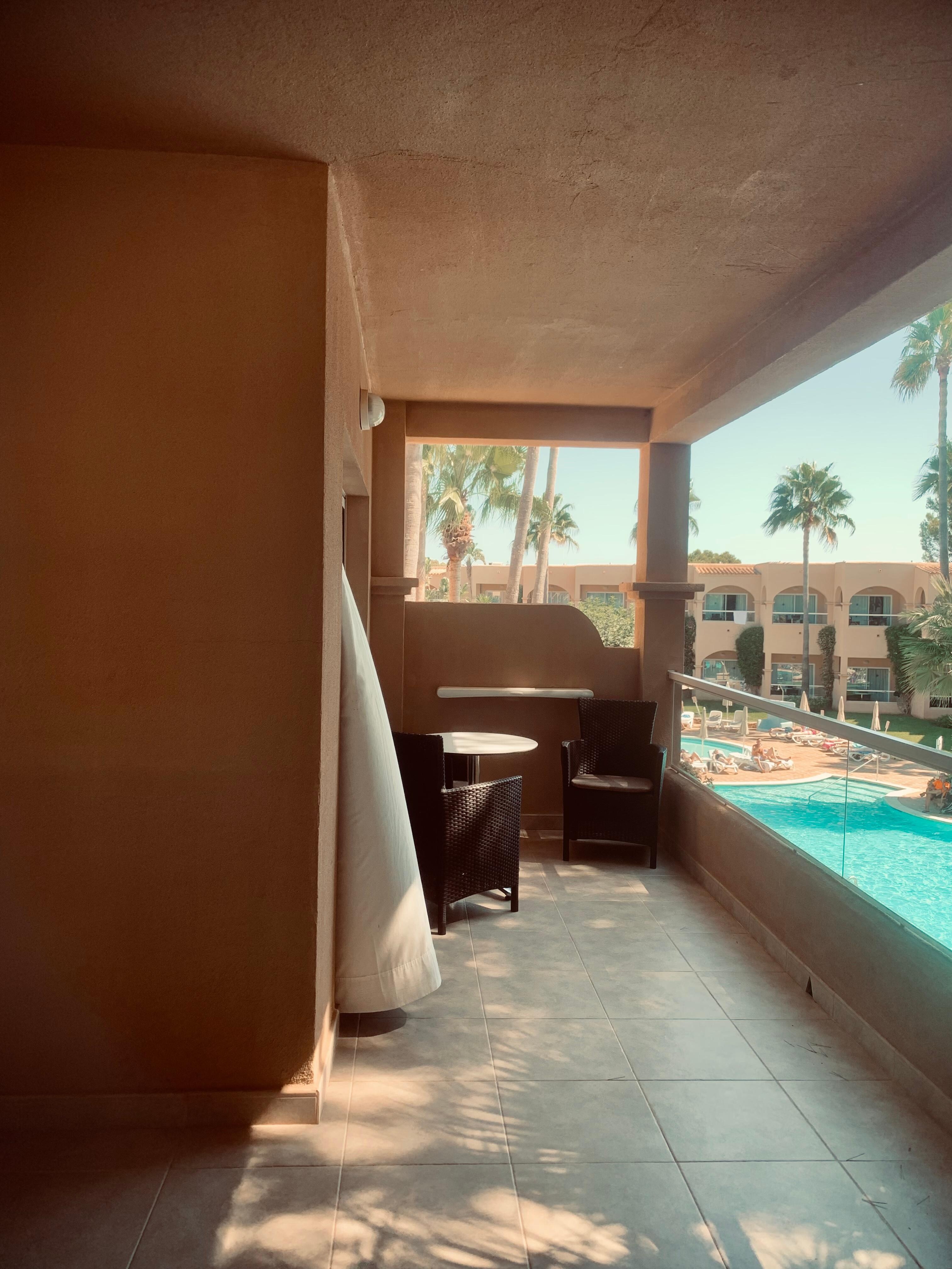 Balcony with table & chairs - overlooking pool