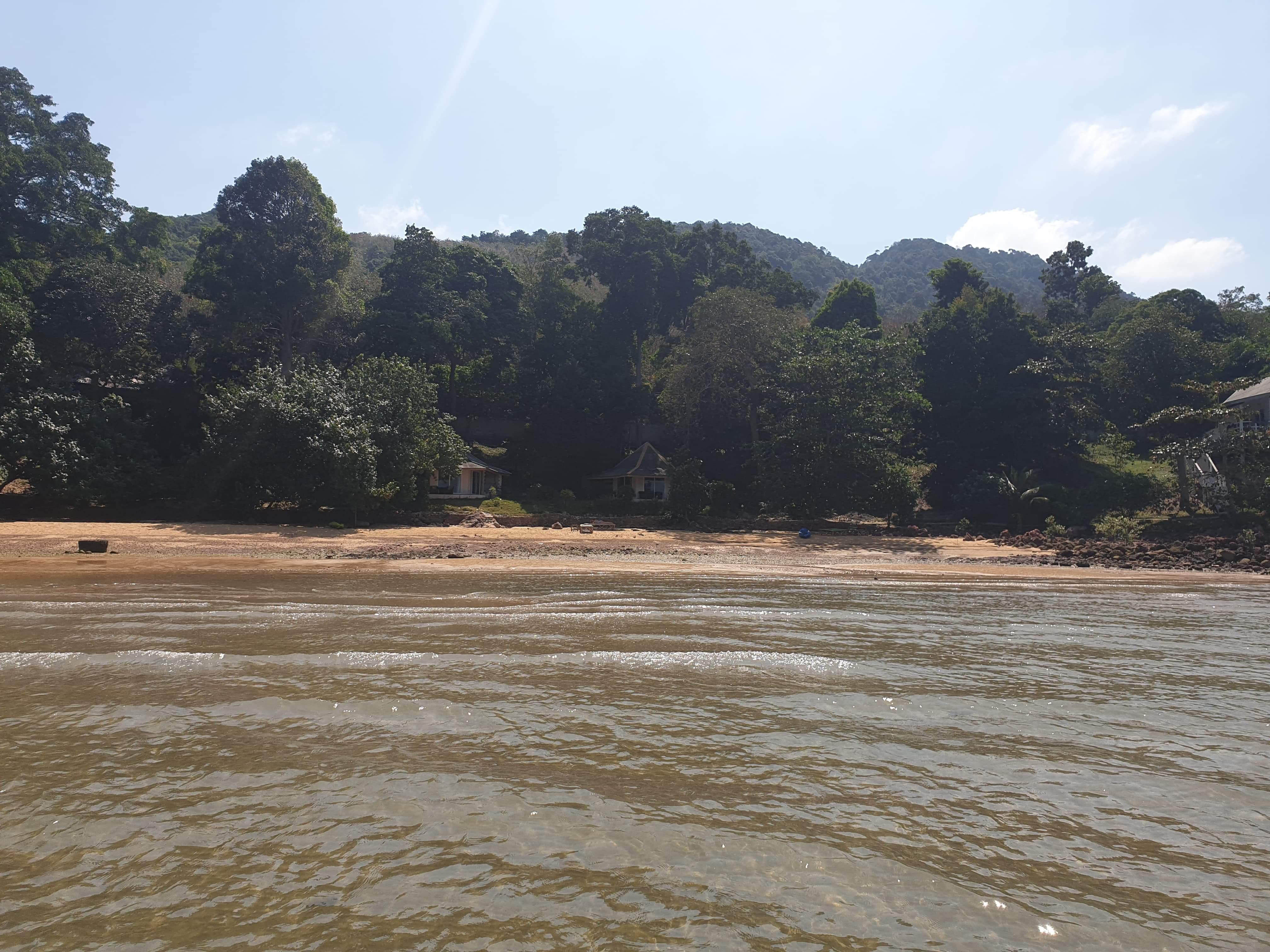 Zoom in to see the little villas nestled in the greenery on the beach