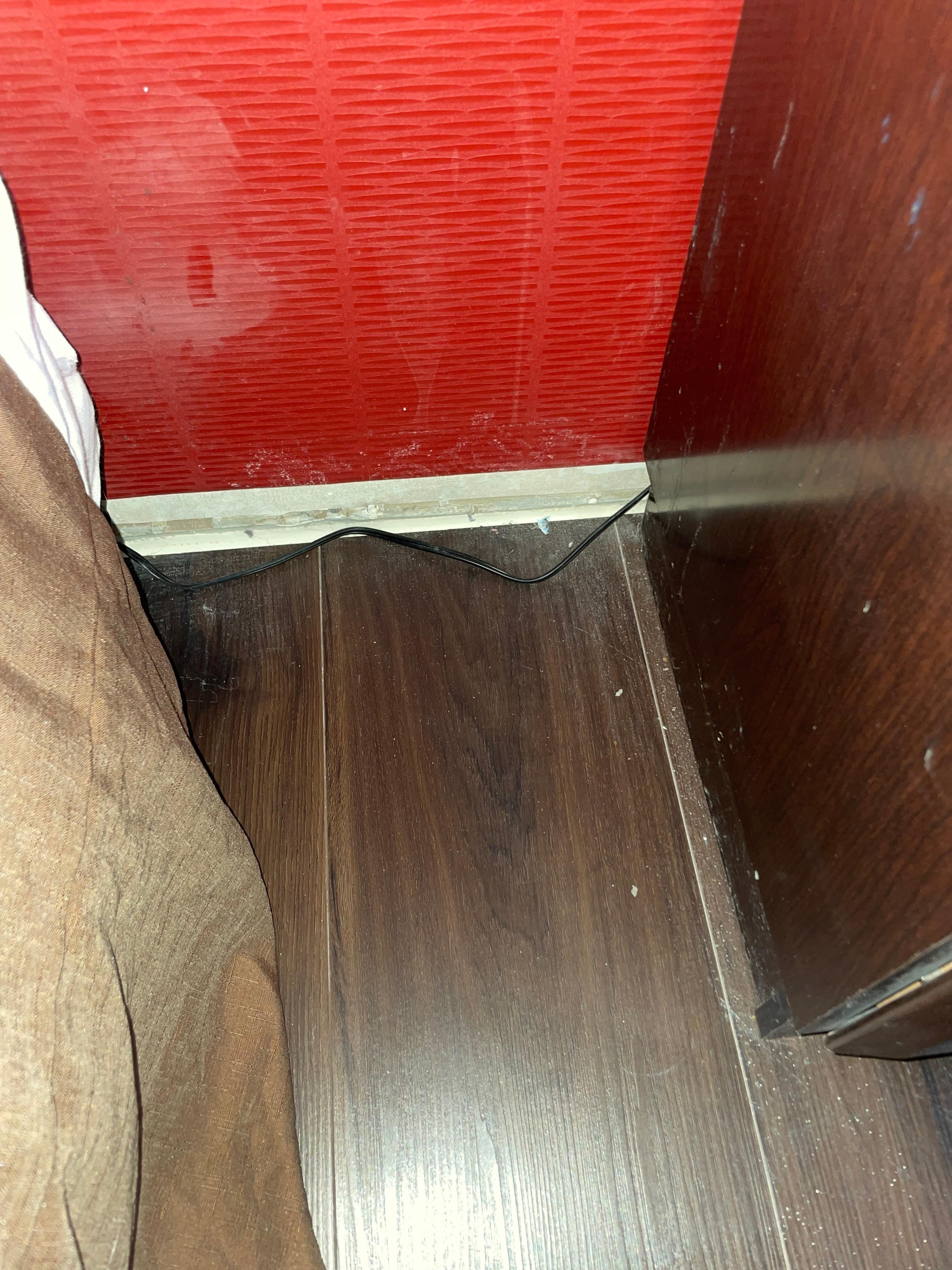 Not only is there no baseboard. The wall is filthy and the floor is filthy too.