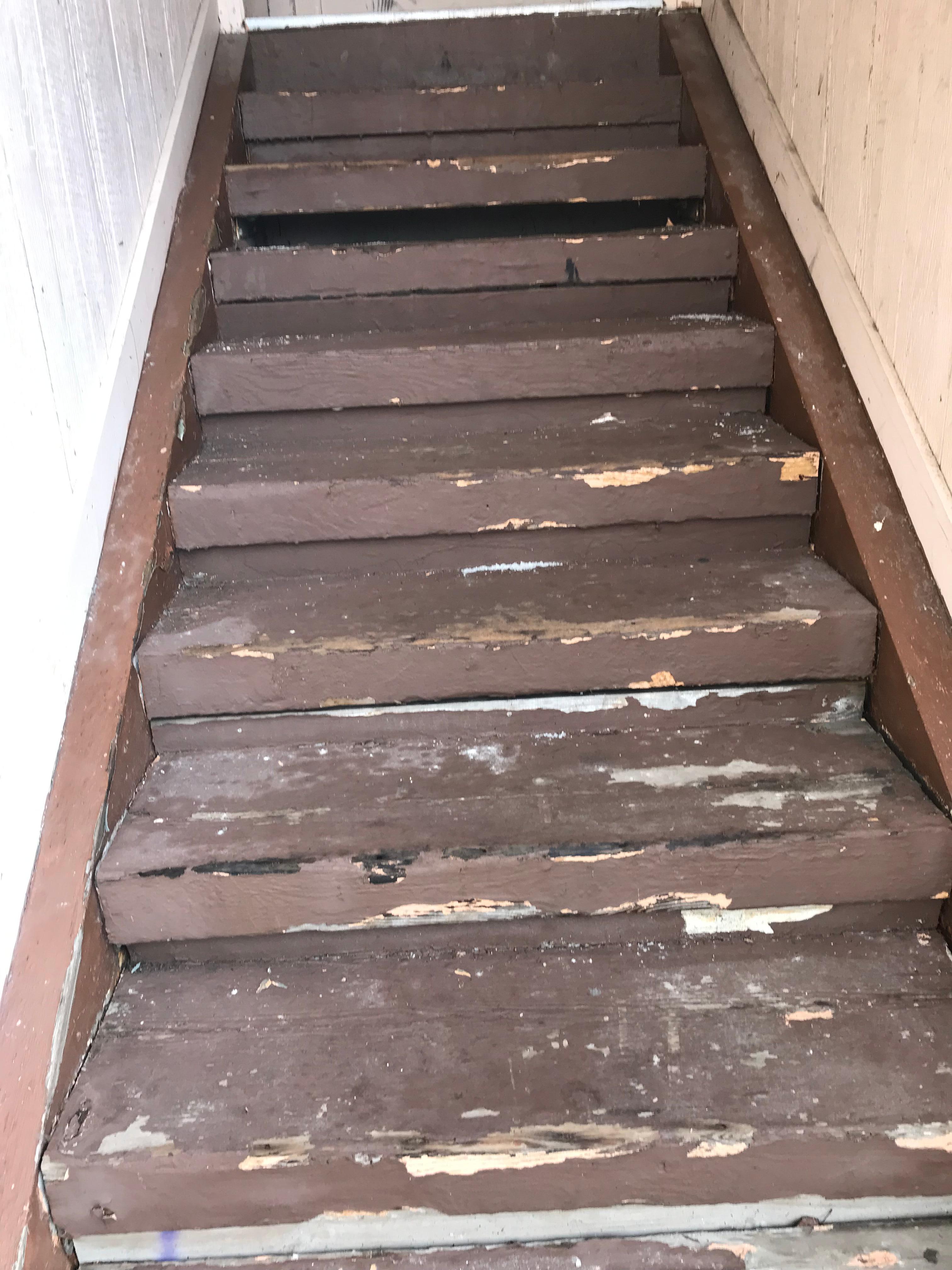 Stairs going to the room in disrepair 