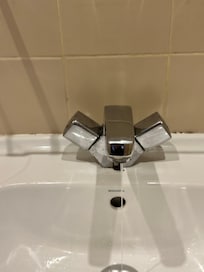 Leaking tap and mould on the tiles.
