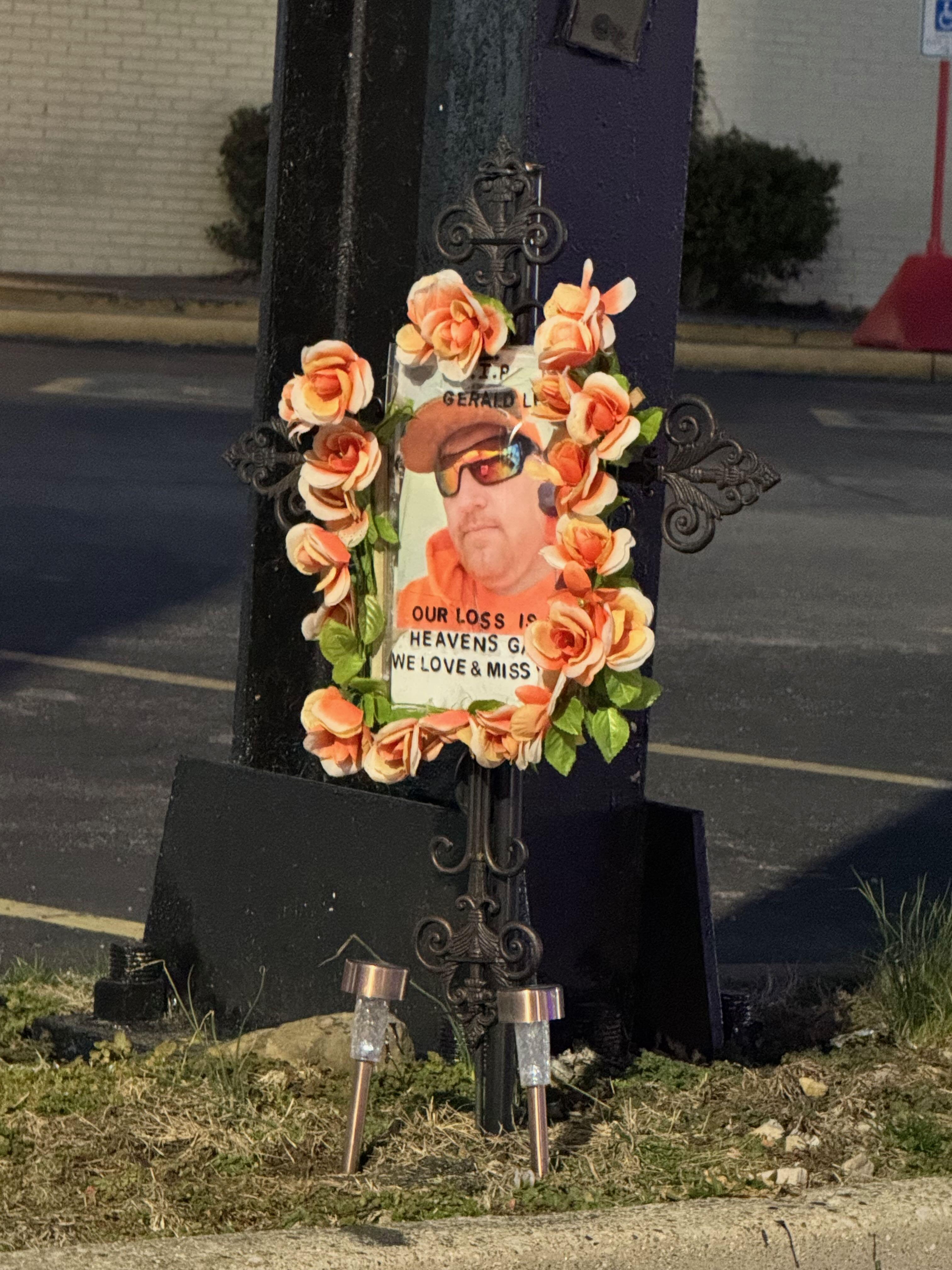 Memorial in parking lot for murder victim. Condolences to the family.