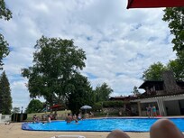 Pool surrounded with beautiful trees.     Locker rooms a bit dated, needing a touch-up
