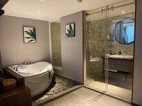 Bathroom area with bathtub and shower. Toilet was Japanese and had all the functions.