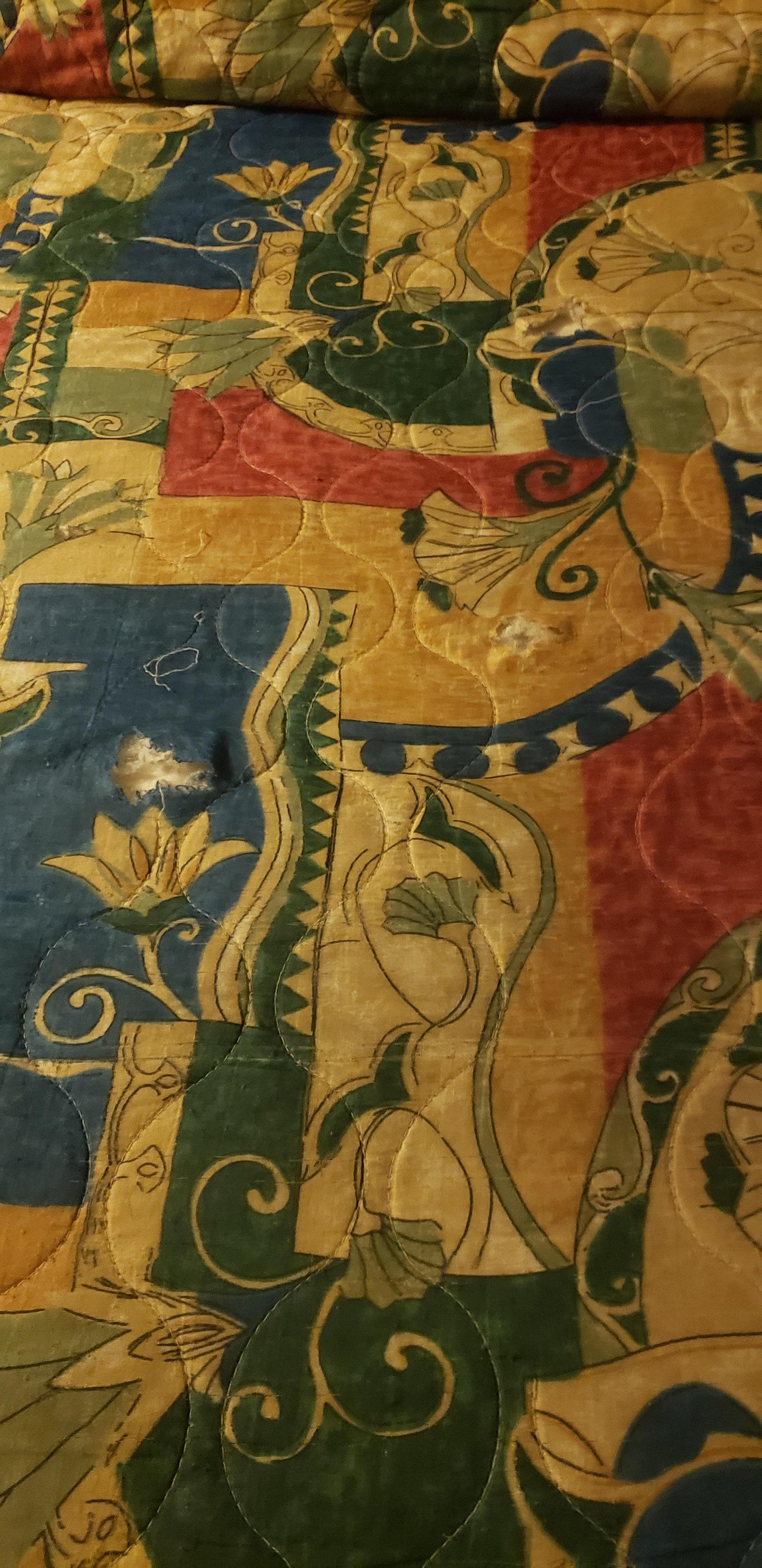 Holes in bed spread.