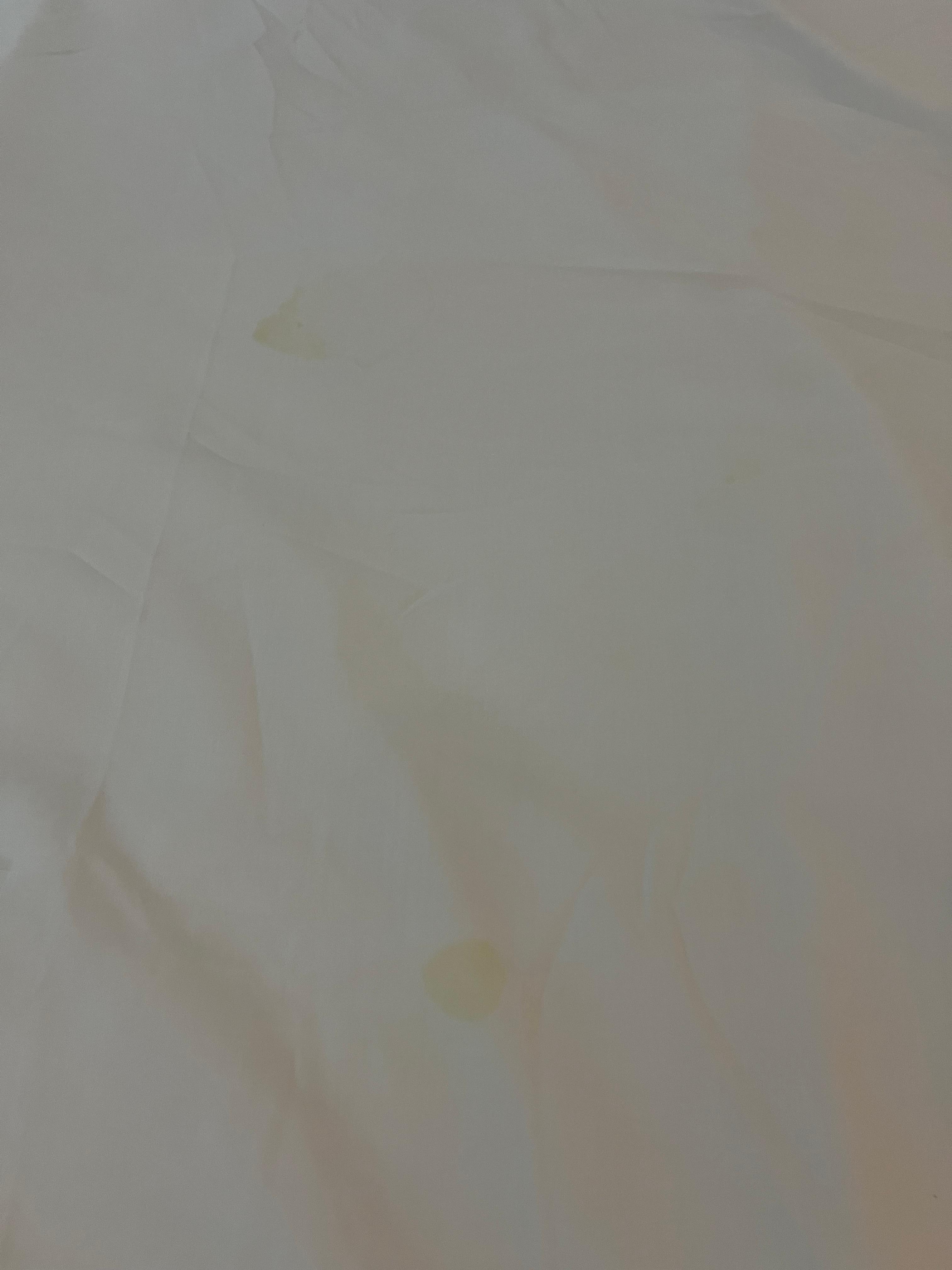 Multiple yellow stains on the bed sheet