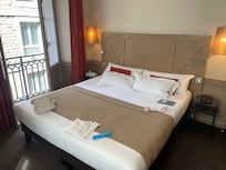 A room w three windows, a great bed, and a strong shower