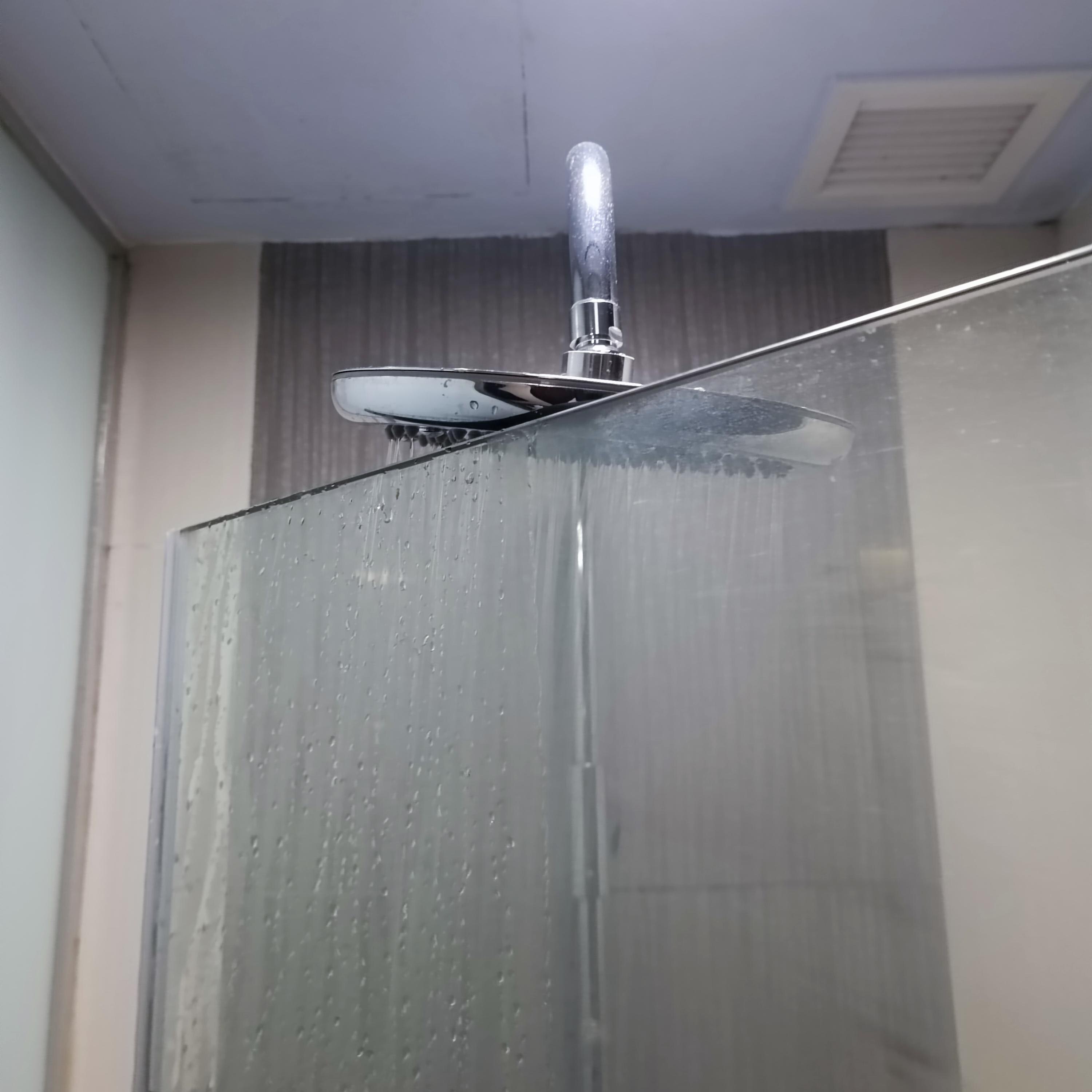 The shower head hits the top of glass door when I opened the door of shower room.
