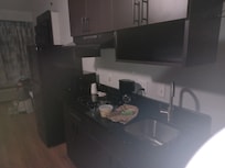 Full fridge, microwave, 2-burner stove top, sink with disposal. Coffee & ice cube trays, too.
Also has iron/board & heavy metal hangers.