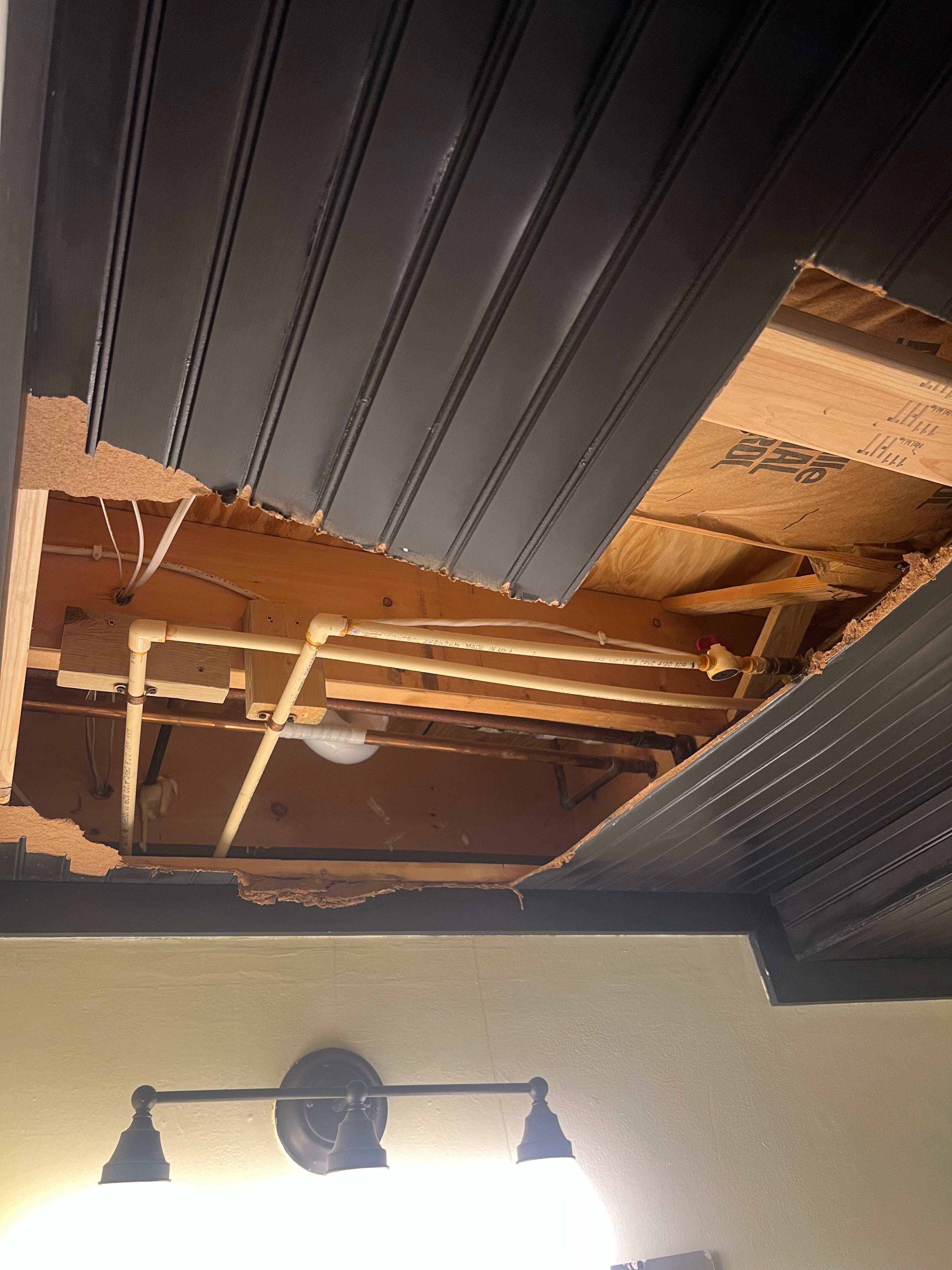 Large hole in downstairs bathroom ceiling