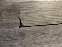 Broken and dangerous living room floor trip hazard