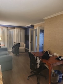 Common area of king bed interior balcony suite.