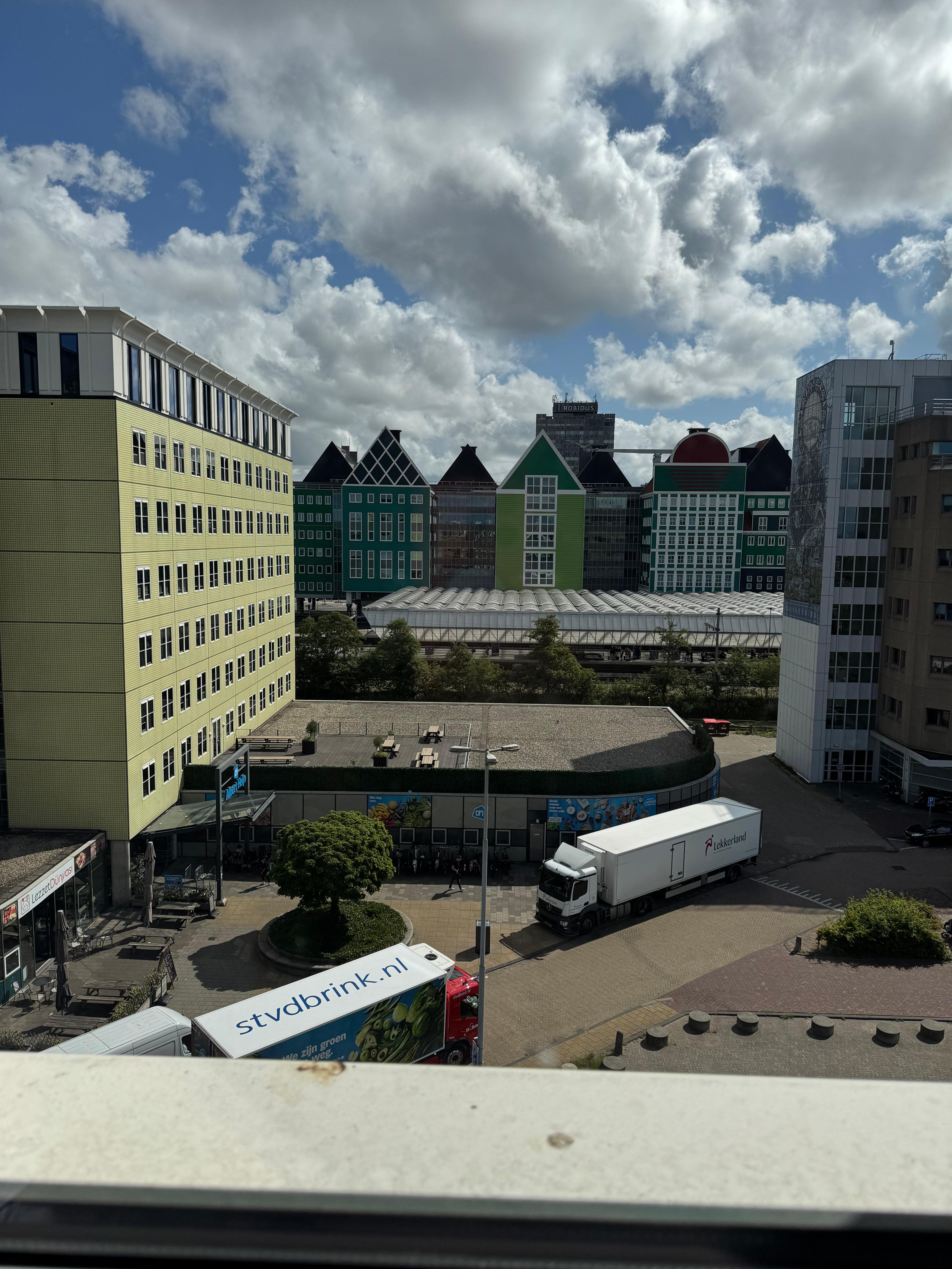 View from hotel room of the train station directly over the road and supermarket bottom left right outside 