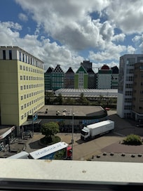 View from hotel room of the train station directly over the road and supermarket bottom left right outside