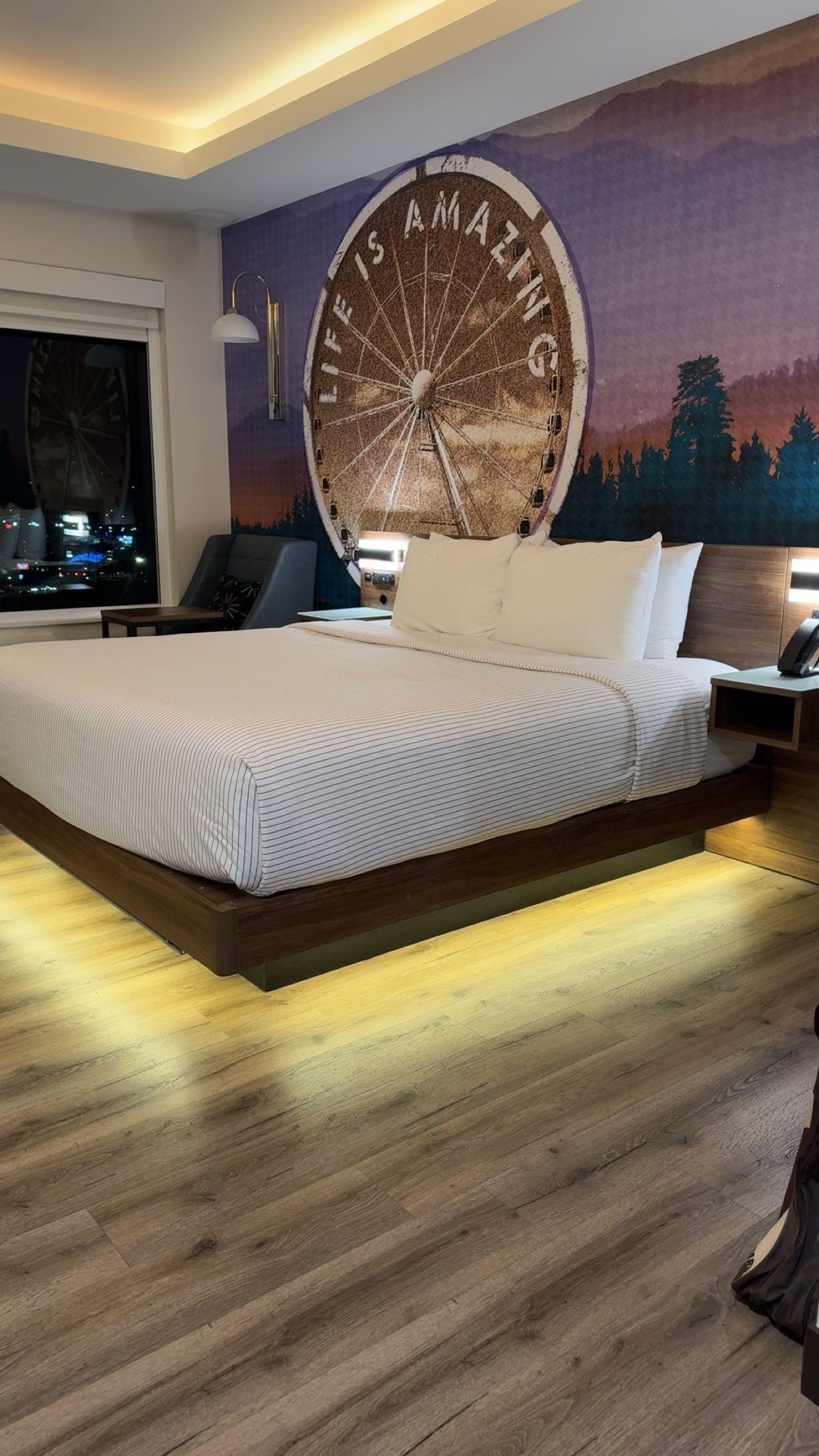 King Size bed with lightening underneath bed and lightening above bed.