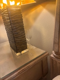 Used wine glass by master bed.