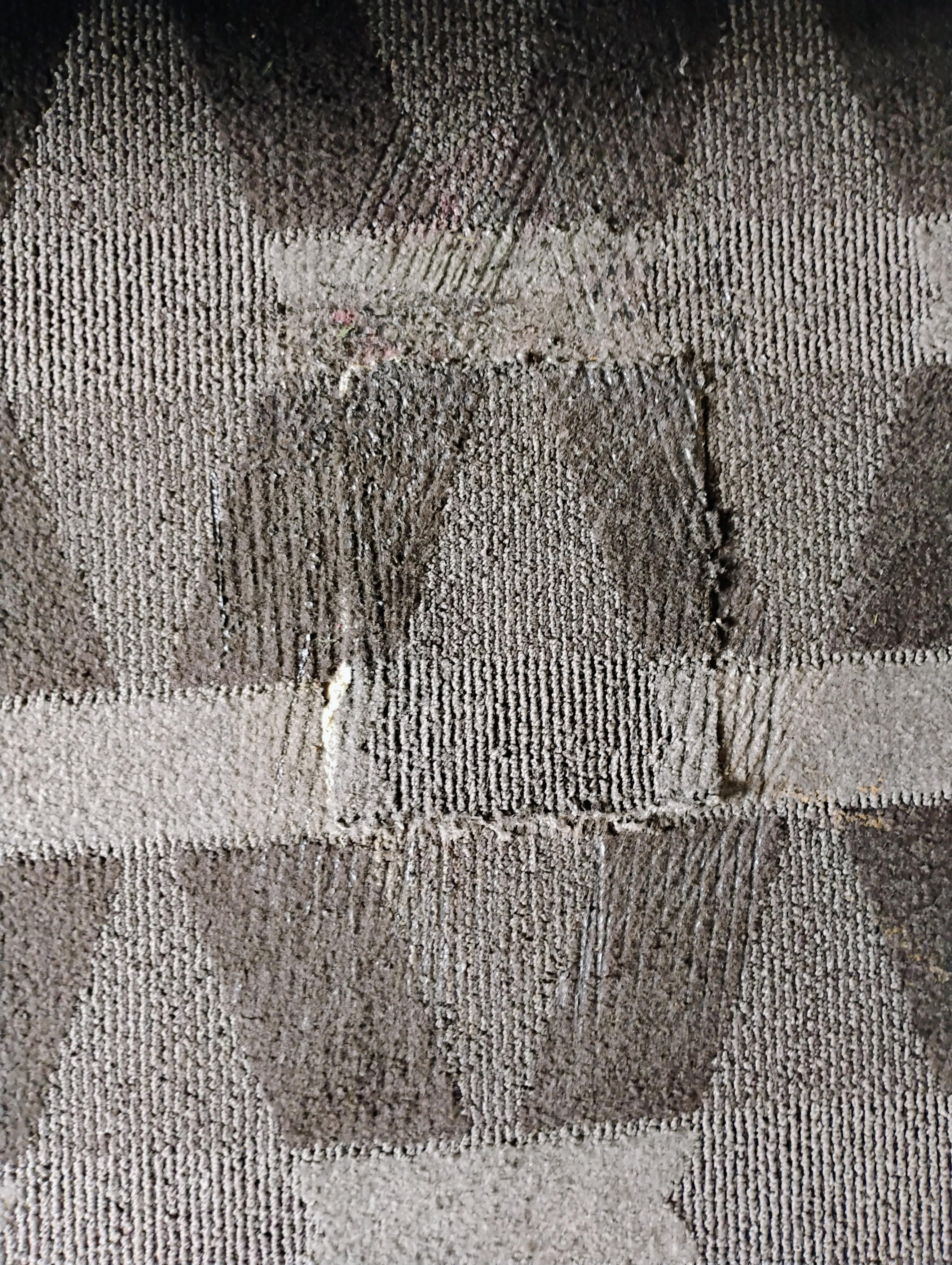 Poorly patched carpet, uneven borders, almost a tripping hazard.