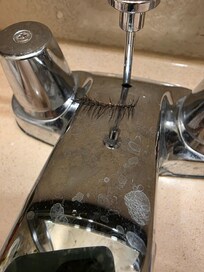 Eyelash in bathroom faucet
