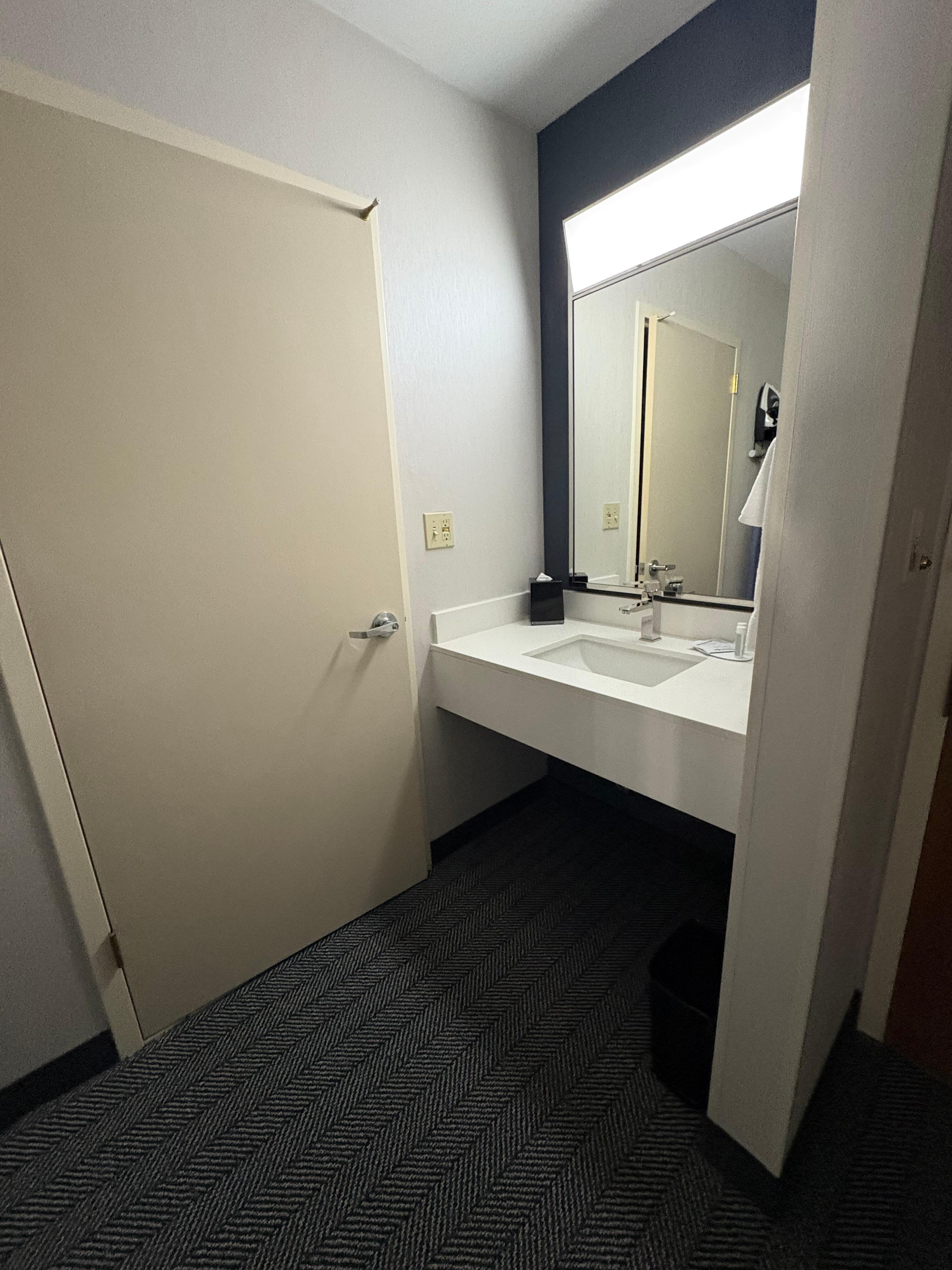 sink and vanity outside of bathroom. 