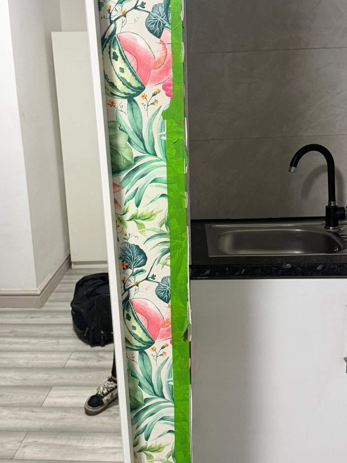 Wallpaper held up using tape