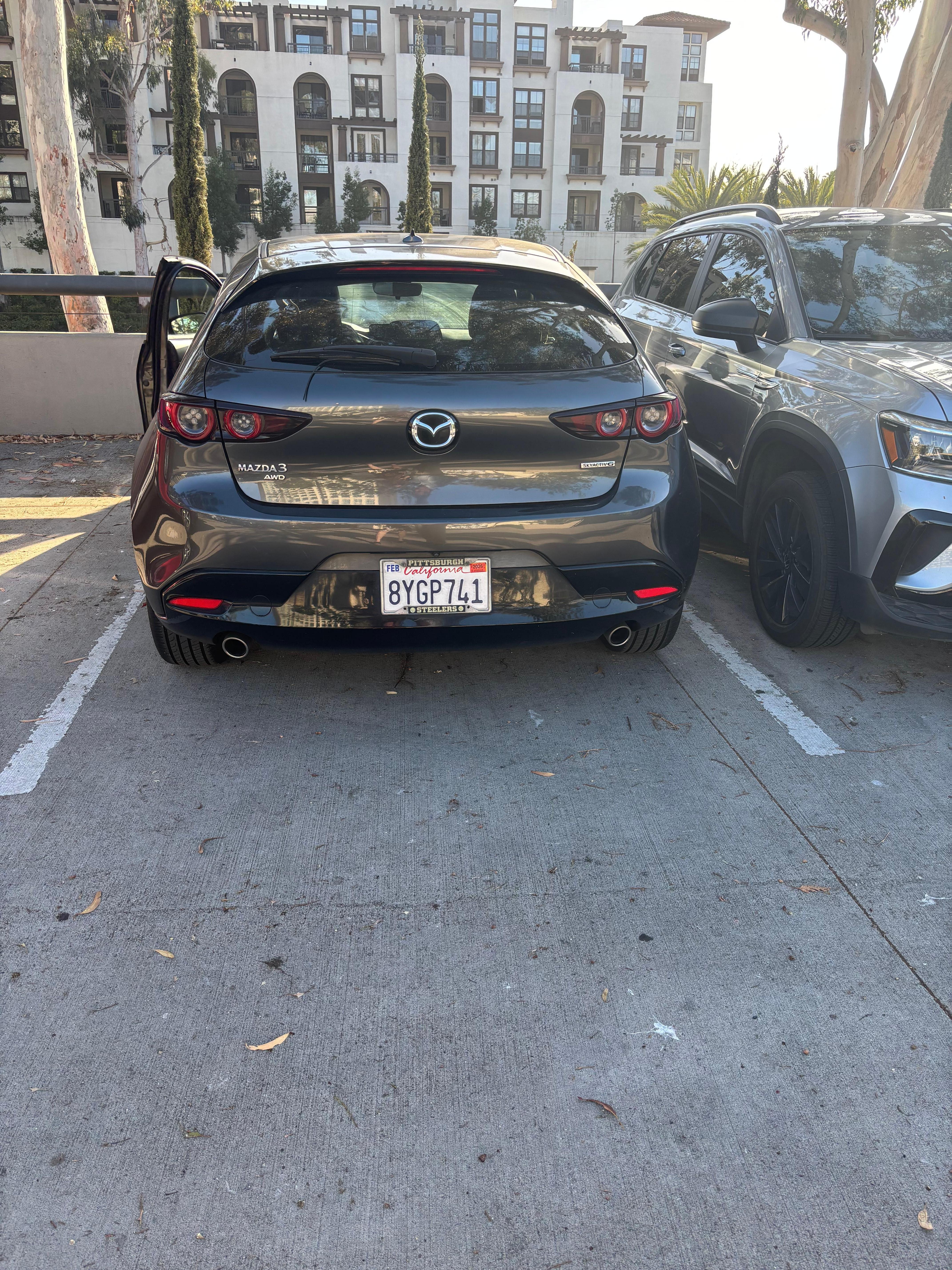 Our massive Mazda parked in the parking lot of hotel. 
