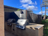 The grills by the dumpster.