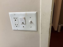 Would you want to touch this bathroom light/plug? zoom in... what is that?!