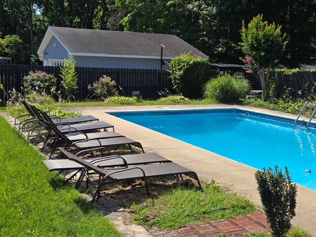 Pool no longer has diving board and lawn overgrown. Ants and high grass under chairs. 