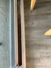 Caked on grime and dirt on both sides of sliding glass doors