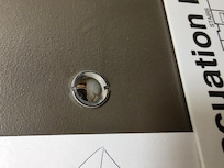 Somthing in the peephole among the other gross stuff in a obviously poorly cleaned room