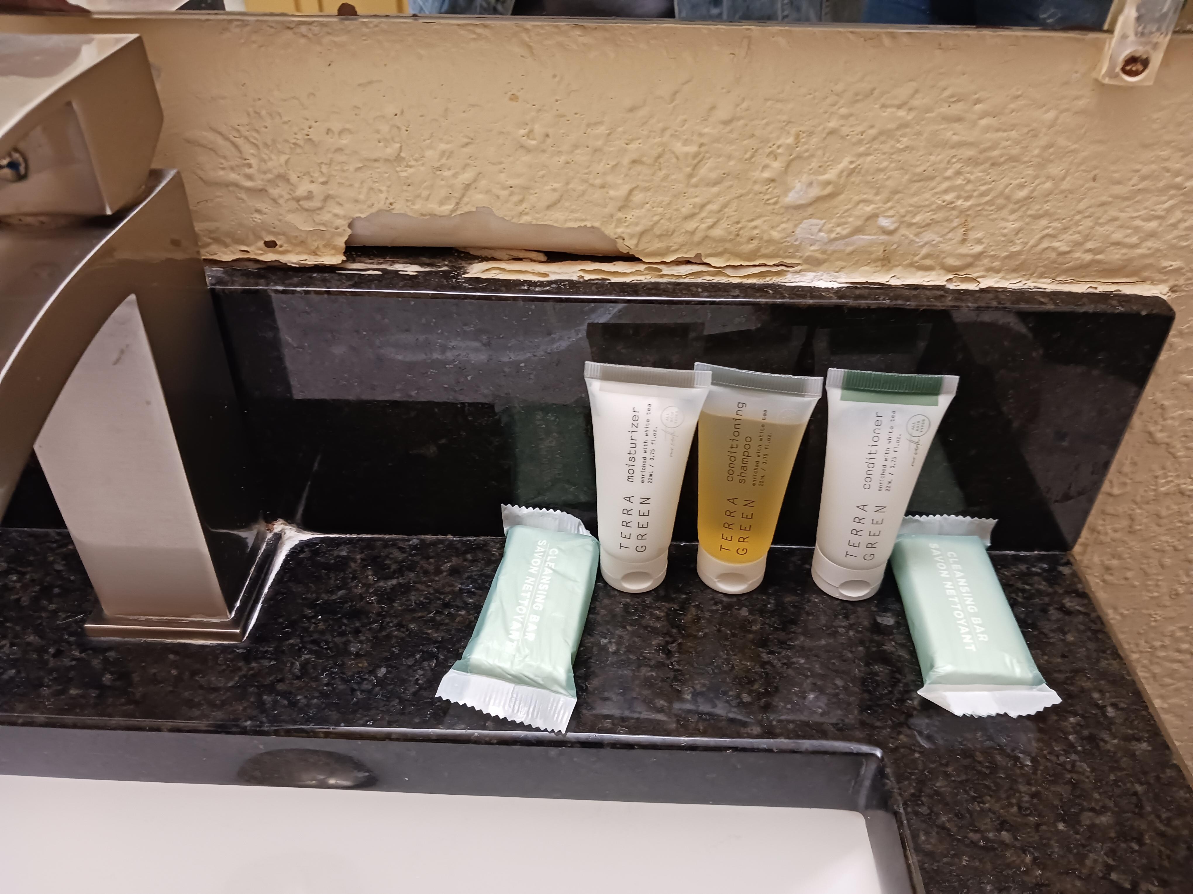 Needs spackling and paint touched up above back splash on sink.