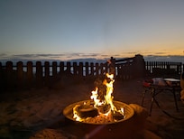 Enjoying the fire pit in the yard while listening to the waves