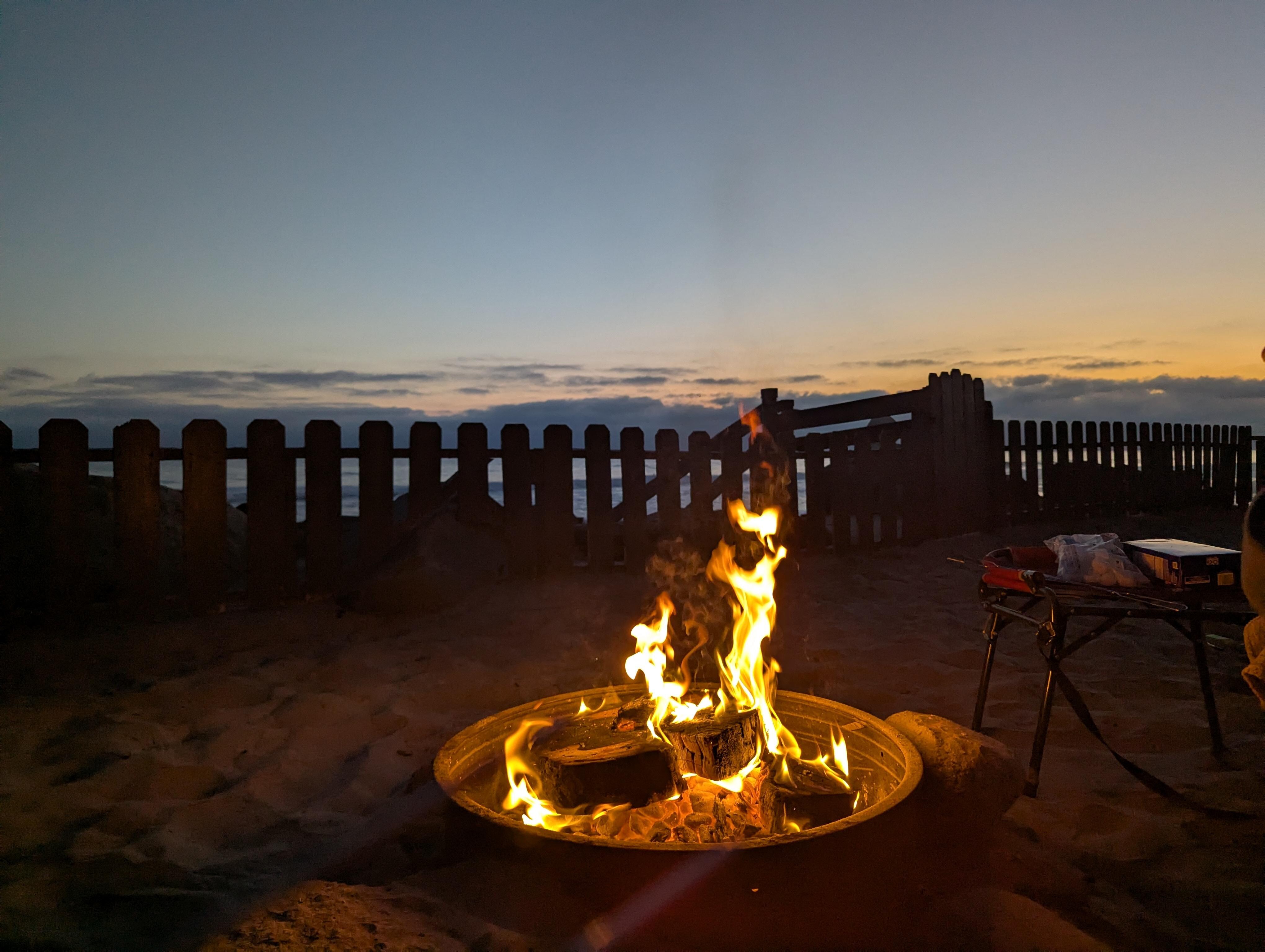 Enjoying the fire pit in the yard while listening to the waves