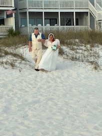 Behind the condo. Perfect quaint path that has lights & and outdoor shower. Powder soft sand.