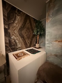 Dusty fake plants and random small carpets