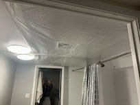 Bathroom ceiling open and only covered by tarp