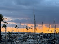Sunset over the harbor . Front of hotel