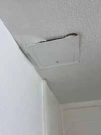 Old falling apart ceiling- when you opened or closed bathroom door stuff fell on the floor
